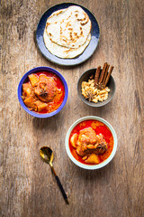 Top view Chicken Magician with red curry mixed with coconut milk served with butter or roti, Roti, local Thai food or Asian food. Massaman curry concept for polite
