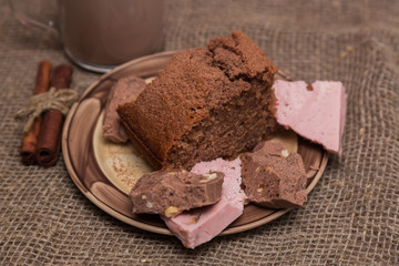 Dessert. Chocolate biscuit cake with cream, cinnamon and berries. Sweet pie with cocoa and chocolate on a wooden board. Copy space