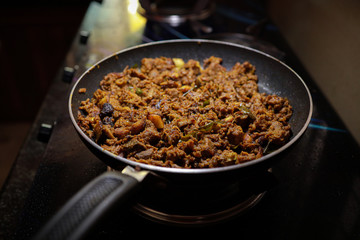 South Indian dish spicy beef fry Kerala, India. side dish ghee rice, appam, parotta, puttu, bread and chappathi, Kerala cuisine ,Buffalo roast / Meat pepper fry with coconut. India spices cooking,