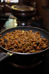 South Indian dish spicy beef fry Kerala, India. side dish ghee rice, appam, parotta, puttu, bread and chappathi, Kerala cuisine ,Buffalo roast / Meat pepper fry with coconut. India spices cooking,