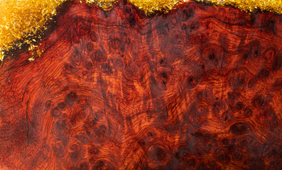 Casting epoxy resin stabilizing Burma padauk wood background texture