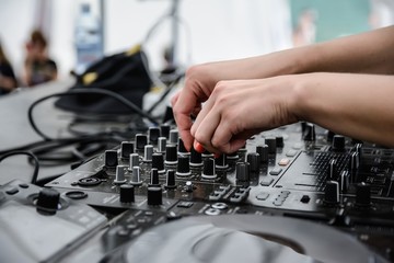 DJ girl hands nails mixes controls