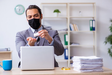 Young male employee in self-quarantine concept