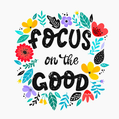 Obraz premium cute hand lettering inspirational quote 'Focus on the good' decorated with abstract flowers and leaves on white background. Good for girly posters, banners, prints, cards, signs, etc. 