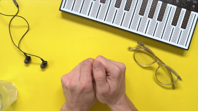 Hands top view. Man using her smartphone with green screen in table , scrolling news, photos. Office desk background.