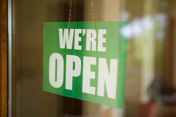 Open sign on the glass of the door at store