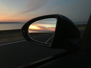 sunset in the car mirror - obrazy, fototapety, plakaty