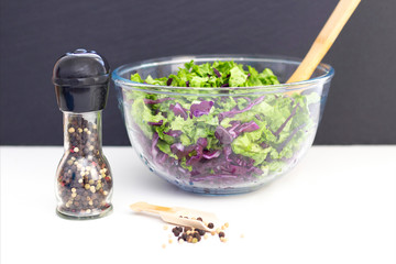vegetarianism. ingredients for a light salad. Purple cabbage, lettuce, peas and olive oil on a white table.