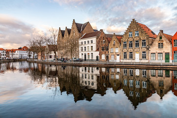 Buildings with reflections  around channels in Bruges at sunset