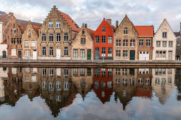 Buildings with reflections  around channels in Bruges at sunset