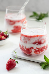 healthy milkshake with fresh strawberries in glasses. delicious breakfast concept. vertical image.