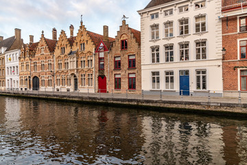 Fototapeta na wymiar Buildings with reflection around channels in Bruges