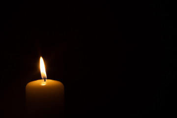 burning candle isolated on black. backgrounds and textures