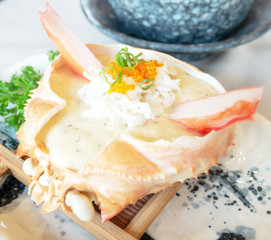 Snow crab baked with mushroom cream sauce on the crab shell.