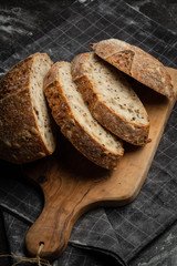 Bread fresh home baking on a wooden board. Black background