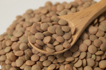 Pile of raw lentil in a spoon