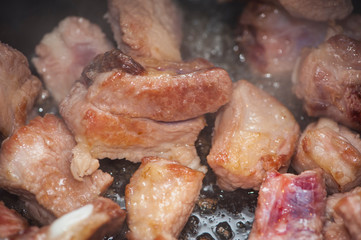 
pieces of meat are fried in oil