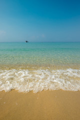 Fototapeta na wymiar Aqua green ocean wave on tropical sandy beach