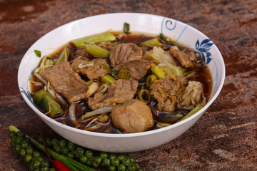 Thai style soup with meat and mushrooms