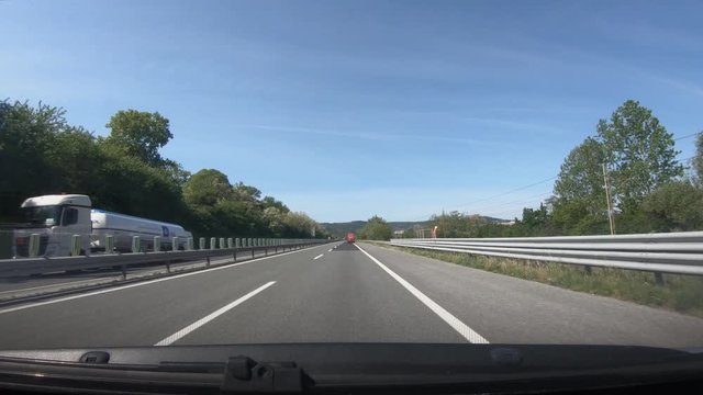 Dashboard point of view POV, driving on Slovenia highway towards Koper. Dashcam view of almost empty asphalt road. Wide shot, forward dolly moving