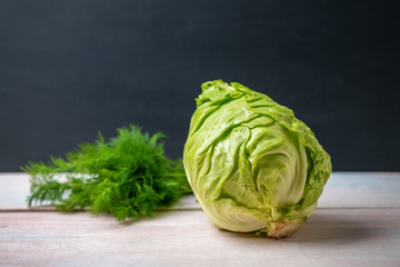 Fresh cabbage and dill on a wooden table