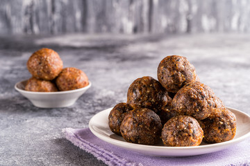 Fruit and nut energy balls in a plate, front view.