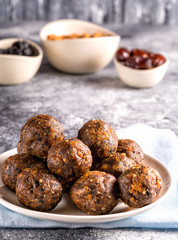 Fruit and nut energy balls in a plate, front view.