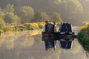 beautiful reflection of the narrow boat in the water in summer