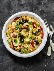 Baked vegetables frittata - delicious appetizer, tapas, snack, breakfast on a dark background, top view