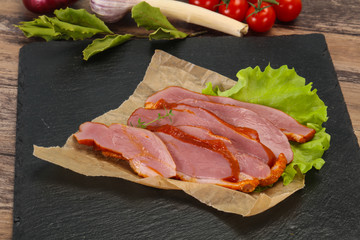 Sliced smoked duck breast served salad