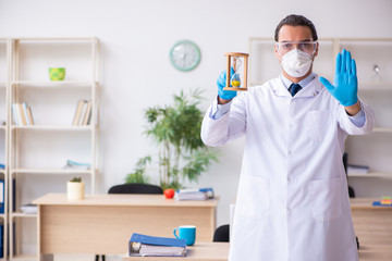 Fototapeta premium Young male doctor virologist in the office