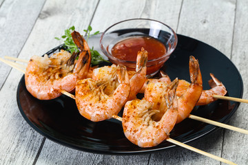 Grilled prawn skewer with sauce