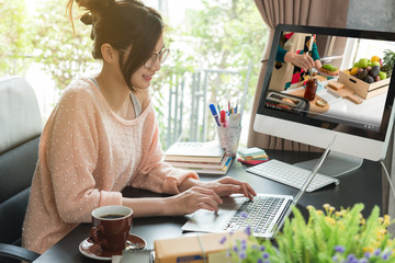 Asian woman work from home during corona virus, COVID-19 out break and learn new skills of own interest while work at home