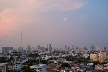 Cityscape from high rise building at night with skyline and clouds. skyscraper in metropolis town with beautiful neon light Bangkok Thailand.