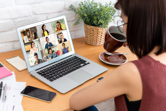 Woman Use Laptop With Screen Of Video Conference Meeting  With 9 Other People, Work From Home Comceptual