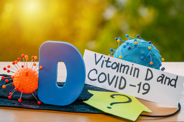 Vitamin D help in treating coronavirus. Vitamin D, coronavirus and question mark on a background of...