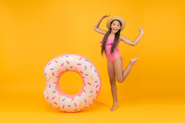 Getting golden tan. little girl going to play in water. having fun on the beach. happy kid on summer beach. Relax in Sea. having fun in waterpark. Girl with inflatable rubber ring at swimming pool