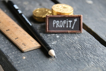 profit concept, stacks of gold coins and a tag with the inscription