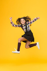 Fototapeta na wymiar Energy and ambition. Energetic girl run to school. Happy child in midair yellow background. Childhood energy. Maintaining kinetic energy. School fashion. Youth and energy