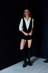 Portrait of a beautiful fashionable blonde woman in black white style dress