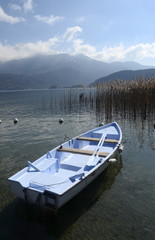 Boat on Annecy lake and mountains, landscape in Savoy
