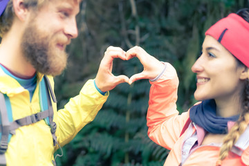 Love couple making heart with hands, free expression of love. Lovers making a heart-shaped symbol...