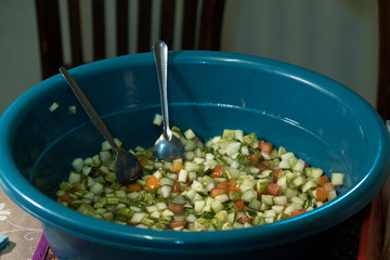 mix salad with two spoon in the basin
