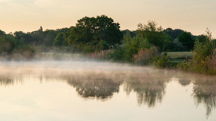 fog covered lake in early morning