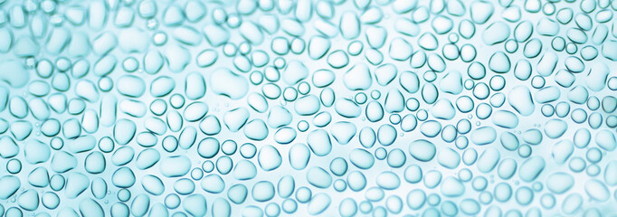Image from microscopy of water drops in the microscopic slide.Abstract oxygen bubbles in the water.Mixed and different shape background in the blue tone.