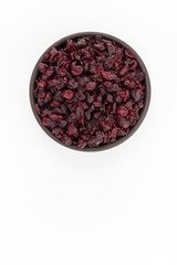 Dried cranberries  in round bowl on white background, top view