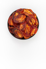 Sun-dried Tomatoes  in round bowl on white background, top view