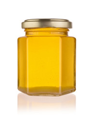 Fresh honey in a glass jar isolated.