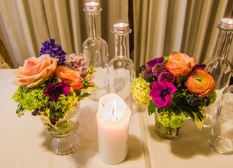 candles and flowers on the laid table to create the right atmosphere for your party