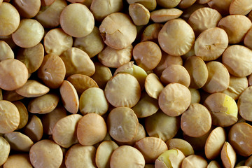 Lentils close-up. Food background. Background texture of grains of green lentils. Top view on lentil grains. Close-up, horizontal, top view, cropped shot. The concept of a healthy diet and agriculture